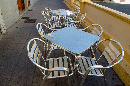 Steel table and chairs in street cafe, Spain