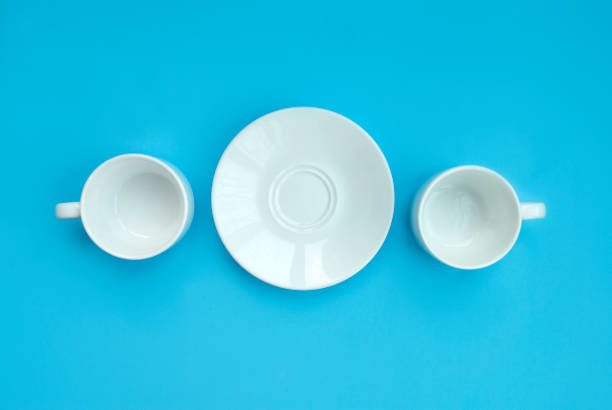 istock Conception good morning. Two white porcelain cups and saucers on a light claw background, top view. Copy space 1207291306