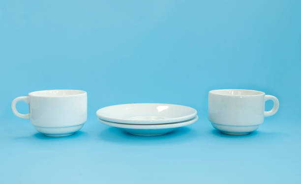 istock Conception good morning. Side view of two white porcelain cups and saucers on a light clawed background. Copy space 1207291309