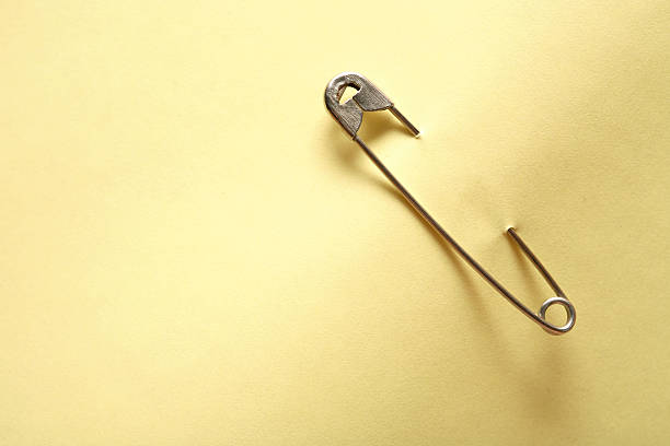Blank yellow adhesive note attached with safety pin