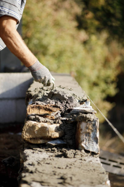 istock Close-up of construction worker builds stone wall 1207292276