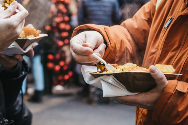istock People holding container with take away food, eating, selective focus. 1207293338