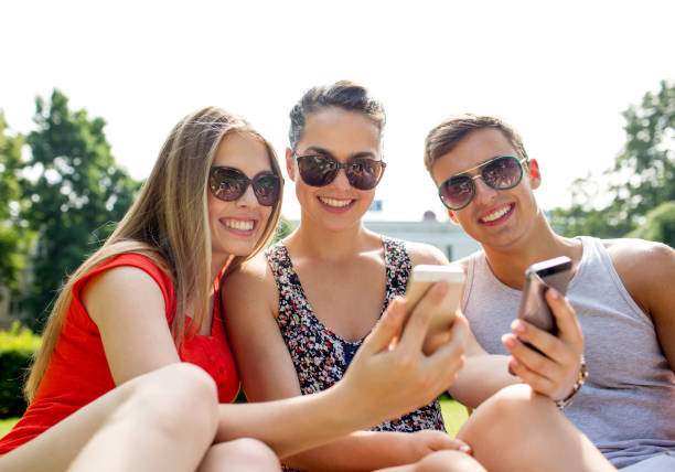 istock smiling friends with smartphone making selfie 1207294566