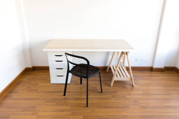 istock working space with wood table and chair in empty room. 1207294850