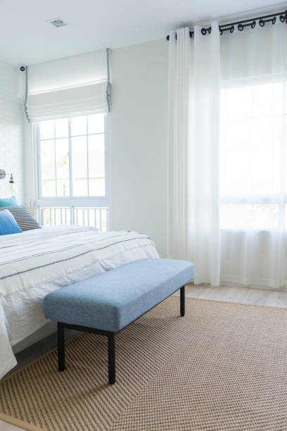 istock Carpet and blue bench in bedroom by the window. 1207294859