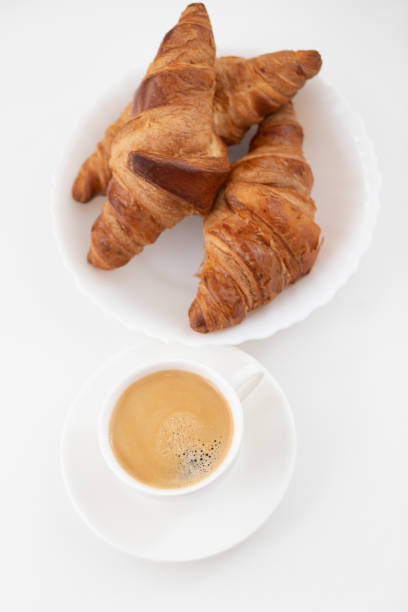 istock Tasty breakfast. Croissants and coffee on the table. Top view. 1207295166