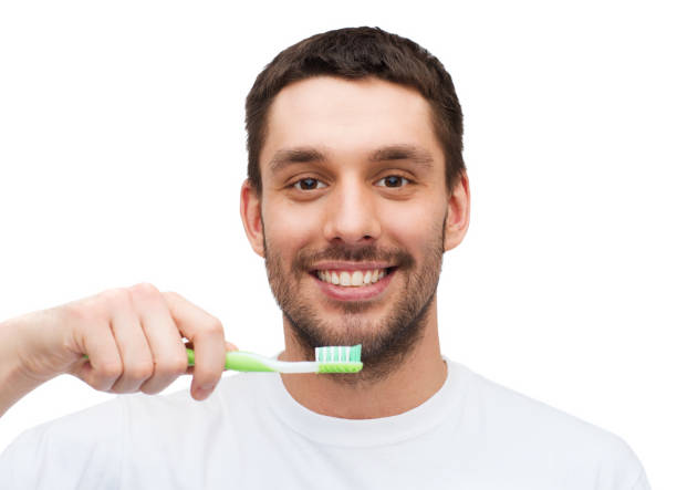 istock smiling young man with toothbrush 1207298437