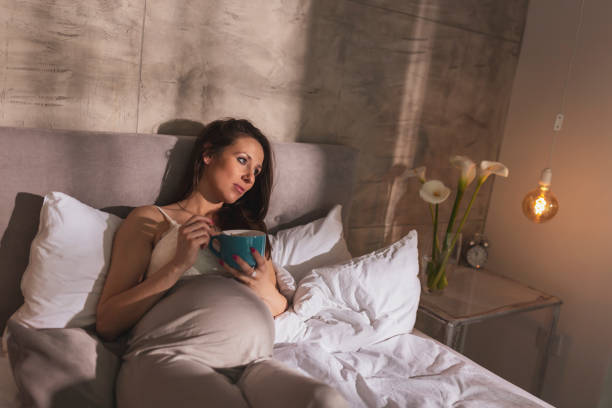 istock Pregnant woman eating cereal for breakfast 1207300060