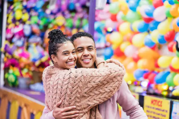 Photo of Young African-American couple playing carnival game