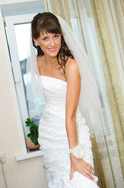 istock beautiful bride standing and smile in white dress 120730103