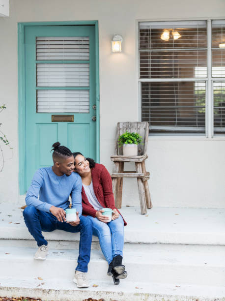 istock African-American couple hanging out, drinking coffee 1207301618