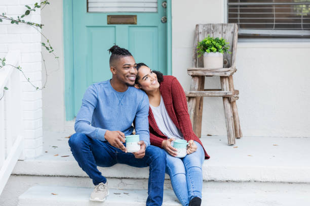 istock African-American couple hanging out, drinking coffee 1207301620