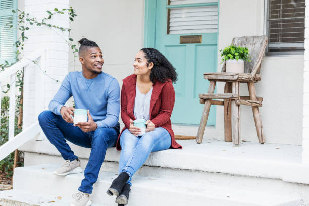 istock African-American couple hanging out, drinking coffee 1207301701