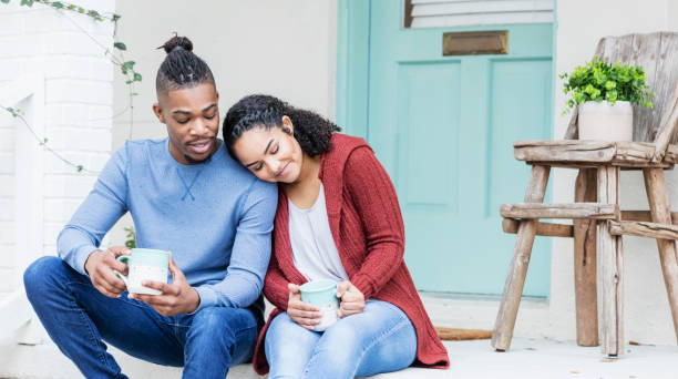 istock African-American couple hanging out, drinking coffee 1207301702
