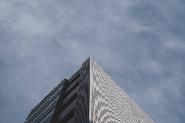 istock Top corner of office building a blue sky. 1207301743
