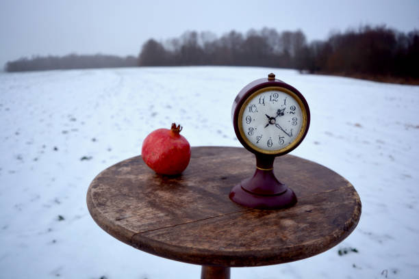 zimowa martwa natura z granatem i starożytnym zegarem na stole - 7292 zdjęcia i obrazy z banku zdjęć