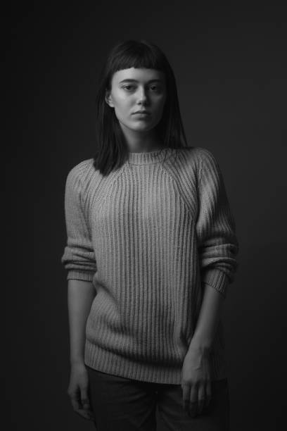 istock Young woman on black background 1207304516