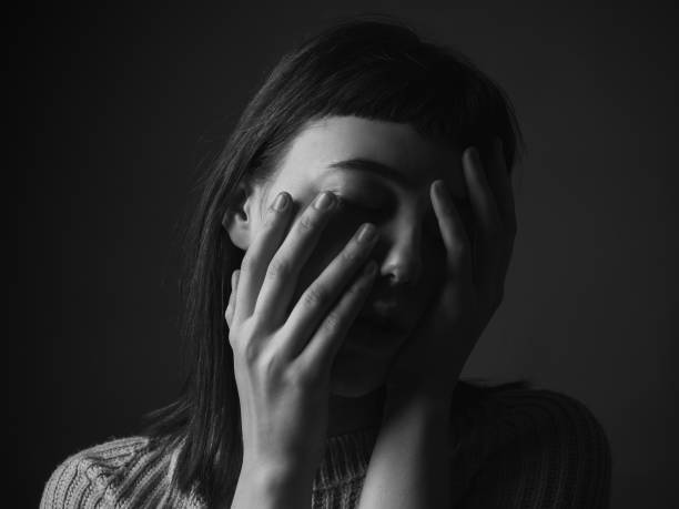 istock Young woman with hands on face 1207304566