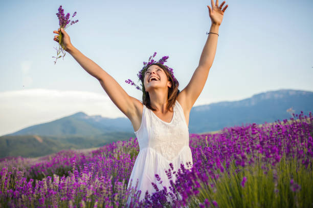istock Beautiful young woman enjoys in fields of lavender 1207304792