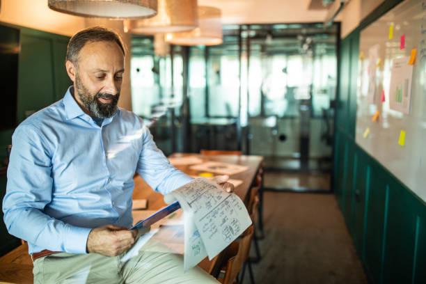 istock Mature businessman working in board room 1207305038
