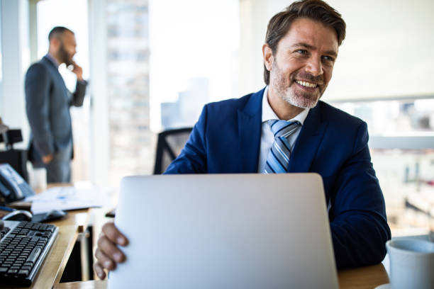 istock Handsome mature businessman working in good mood 1207305075