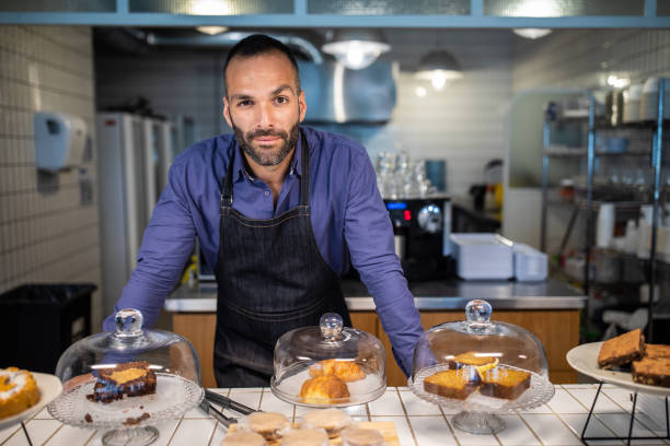 istock Confident entrepreneur standing in his bakery shop 1207306280
