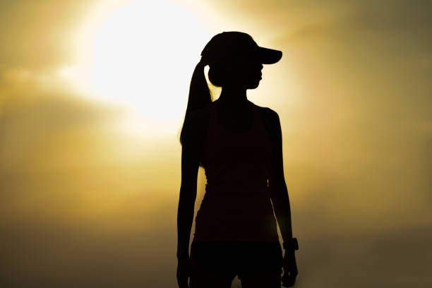 istock Silhouette of a female runner, she stands 1207306560