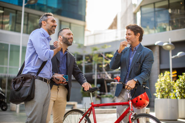 istock Happy colleagues talking after work in front of office building 1207306616