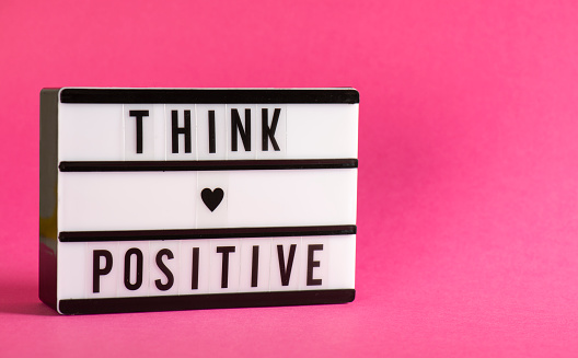 Think Positive message in light box. Lightbox on the white background.