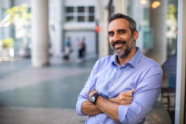 istock Confident Latin businessman in front of office building 1207308201