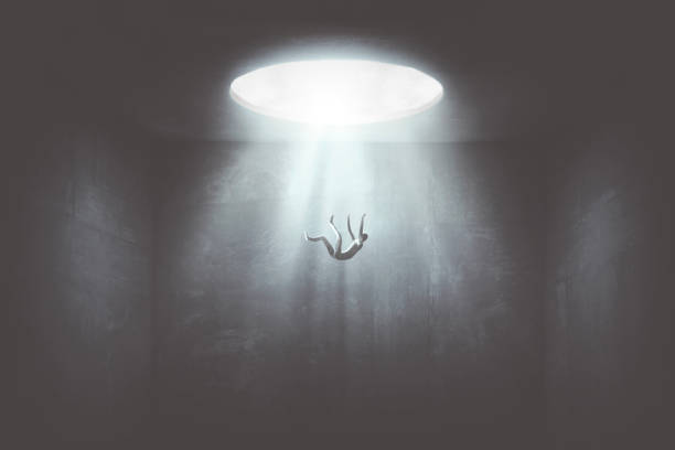 man falling down from a hole of light, surreal concept man falling in the void from big hole surreal concept sink photos stock pictures, royalty-free photos & images