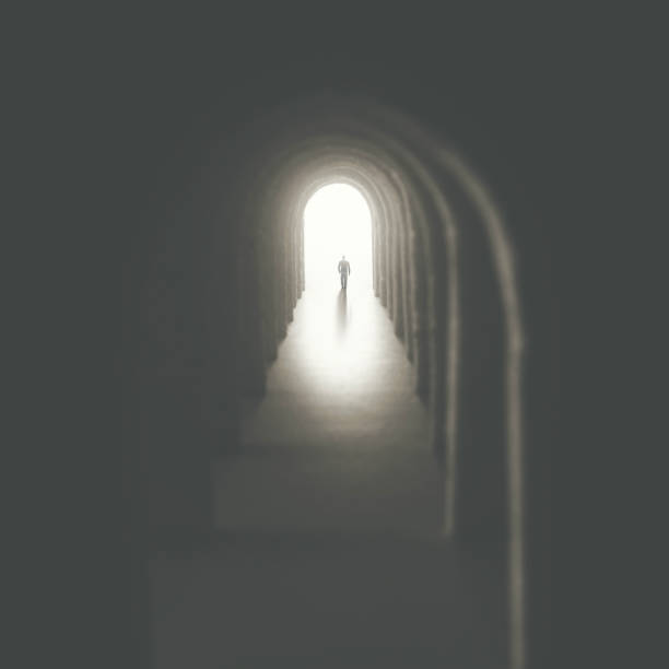 istock man walking into a tunnel of arches gothic style 1207309926