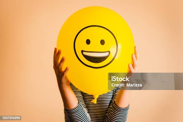 Child Holding Yellow Balloon In The Hands Stock Photo - Download Image Now - Happiness, Anthropomorphic Smiley Face, Smiling