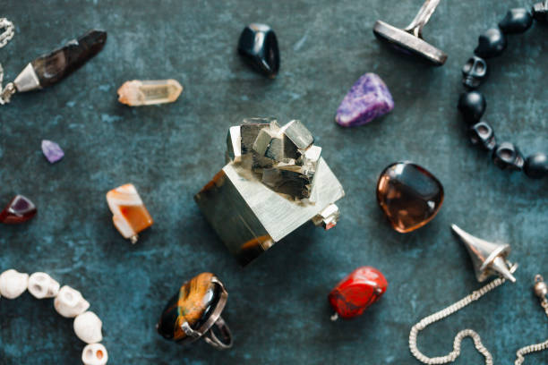 istock Magic flat lay. Various precious and semiprecious stones on a blue background for witchcraft. 1207314291