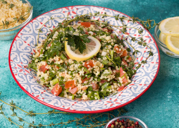 istock Tabule - oriental salad, appetizer on a blue background close-up next to the ingredients 1207314377