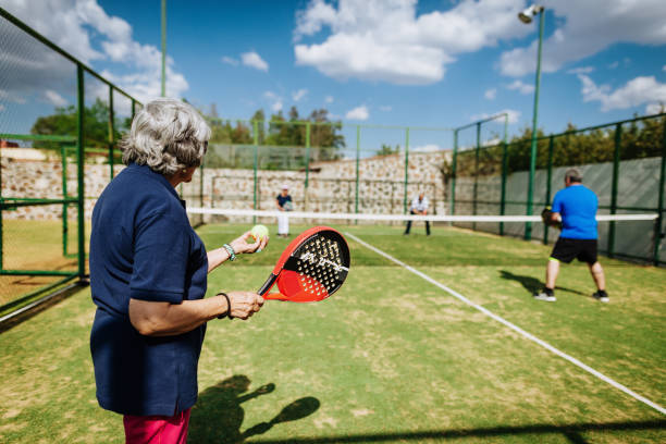 istock Latin senior women playing paddle tennis outdoors in springtime 1207316445