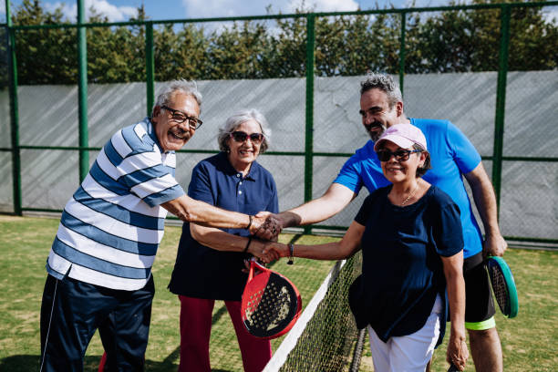 istock Latin seniors playing paddle tennis outdoors in springtime 1207316585
