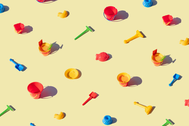 Children beach toys isolated on yellow background
