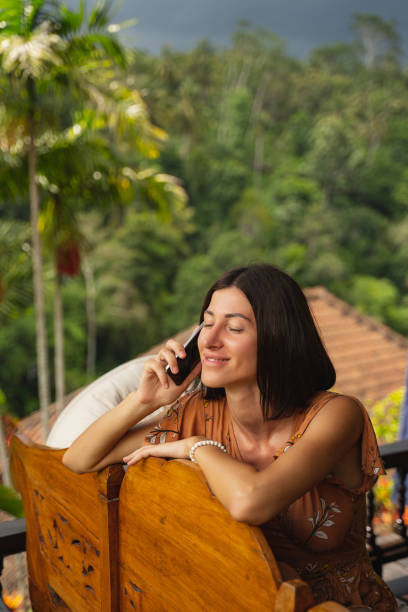 istock Charming young woman sitting on wooden couch 1207317421