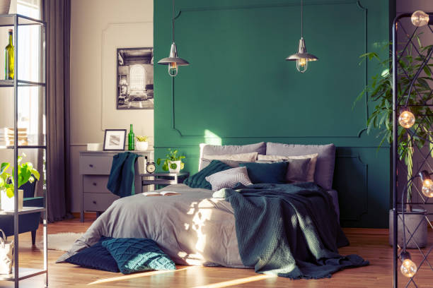 istock Copy space on empty green wall of elegant bedroom interior 1207317727