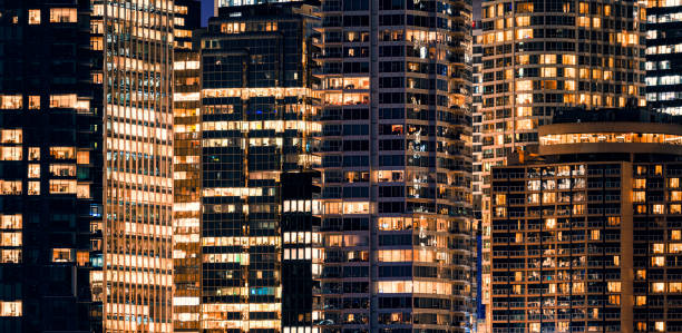 istock Facade windows of illuminated modern skyscraper with office building at night 1207319216