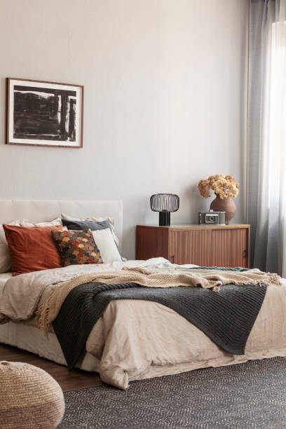 istock Cozy pillows on comfortable big king size bed in bright bedroom interior in elegant apartment 1207320910