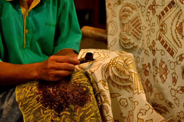 istock Closeup of a worker who paints Batik fabric 1207321156