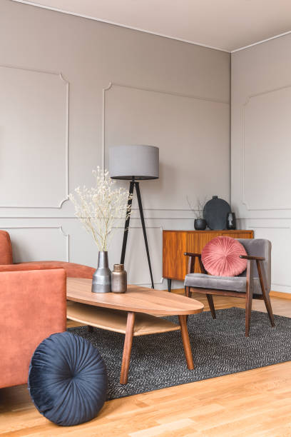 istock Stylish tall grey lamp in elegant living room interior with comfortable brown corner sofa 1207321400