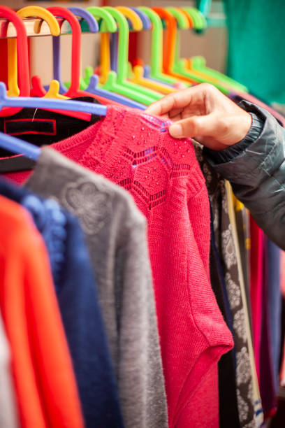 istock Hand choosing clothes for shopping. 1207321501