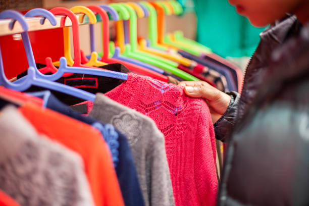 istock Hand choosing clothes for shopping. 1207321635