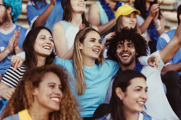 istock Happy Argentinian soccer fans watching a match in stadium 1207321749