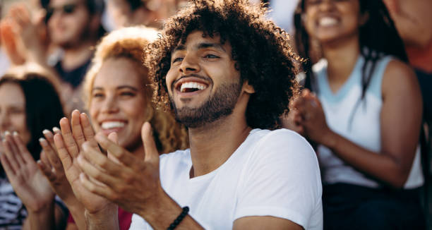 istock Smiling man watching a soccer match at stadium 1207322834