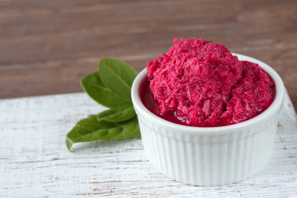 Homemade horseradish in beetroot juice in a white plate. Hot spicy seasoning. Fermented foods. Homemade horseradish in beetroot juice in a white plate. Hot spicy seasoning. Fermented foods. Vegetarian super food. horseradish stock pictures, royalty-free photos & images