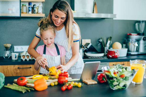 istock Mother and daughter making a salad 1207327928